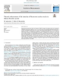 Thermal enhancement of the intensity of fluorescent nuclear tracks in lithium fluoride crystals